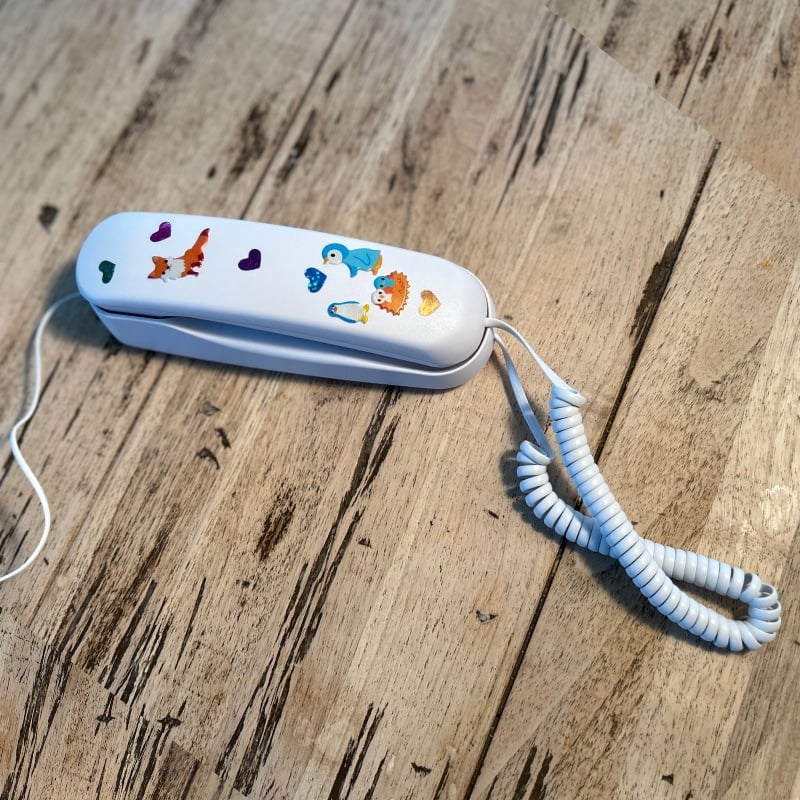 Pinwheel Home Phone with stickers on table