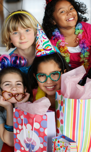 Group of kids with birthday hats and presents